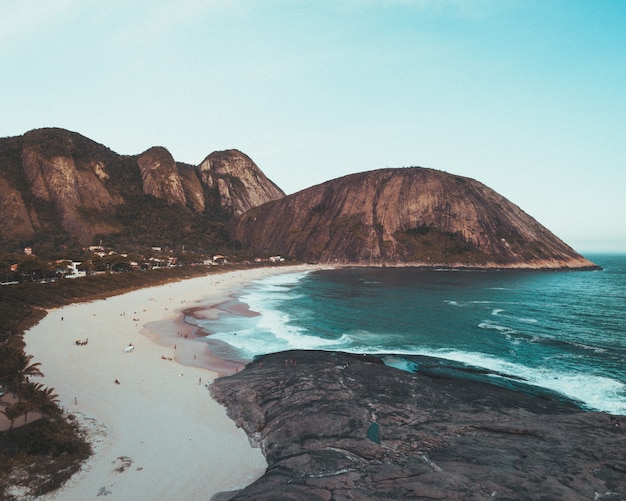 Sandy coast of a beautiful sea with clear blue sky and sunlight