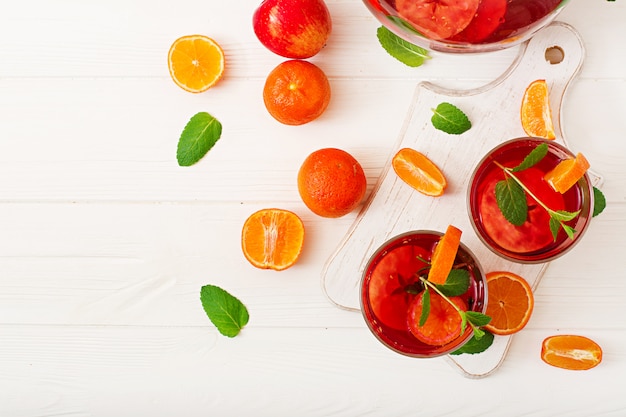 Sangria with fruits and mint on a white