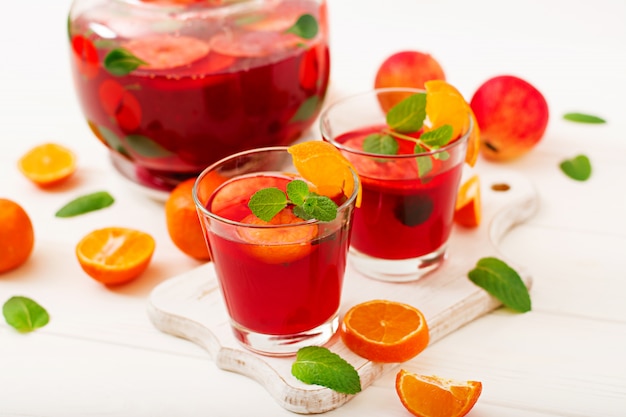 Sangria with fruits and mint on a white