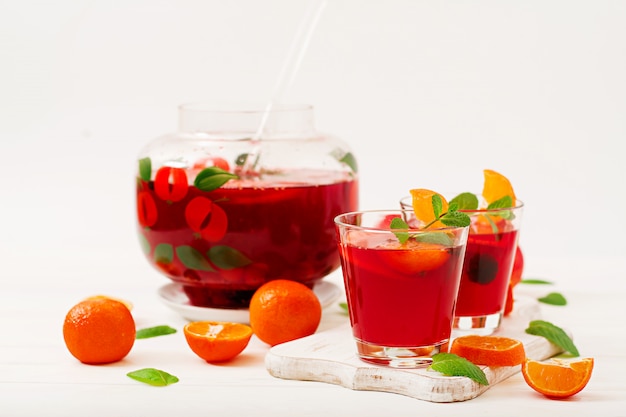 Sangria with fruits and mint on a white