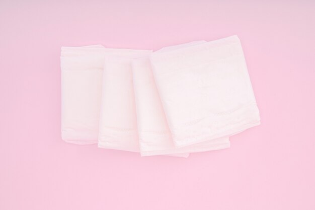 Sanitary pads on a pink scene