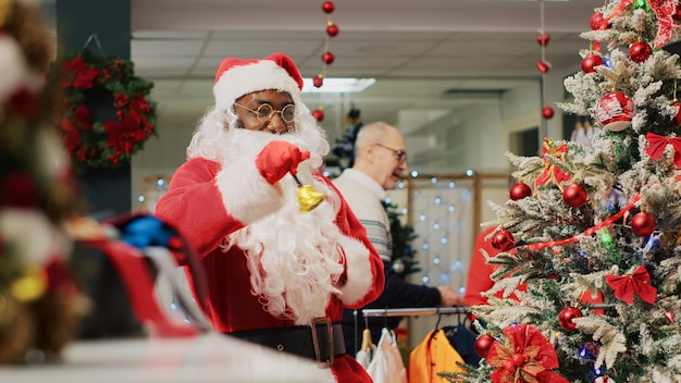 Free photo santa claus employee entertains shoppers