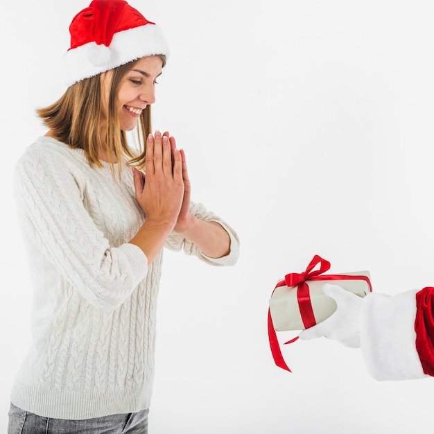 Santa Claus giving gift box to happy woman