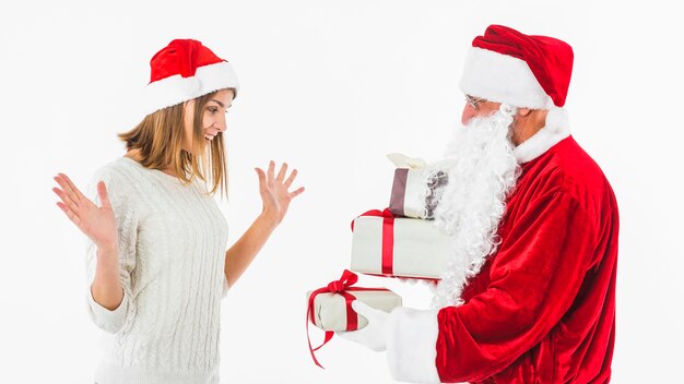 Santa Claus giving small gift box to woman