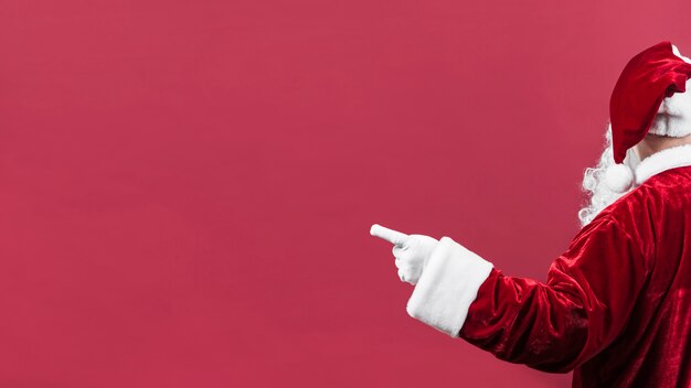 Santa Claus in hat pointing left 