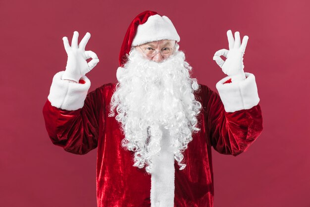 Santa Claus in hat showing okay gestures