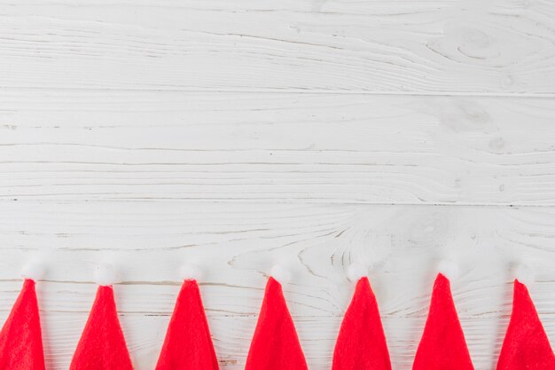 Santa Claus hats on wooden table