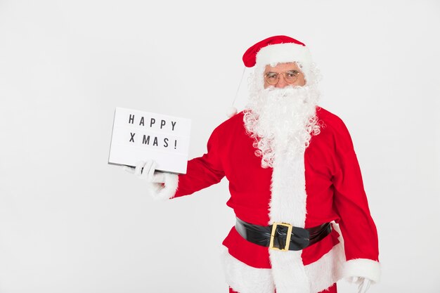 Santa Claus holding greeting board