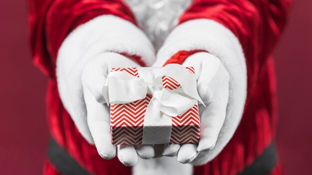 Santa Claus holding small gift box in hands 