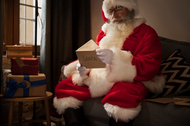 Santa claus opening a letter from a kid
