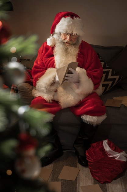 Santa claus opening a letter from a kid