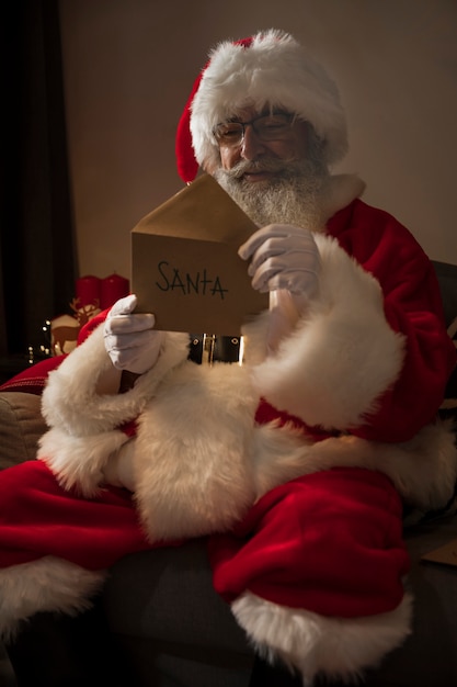 Santa claus opening a letter from a kid