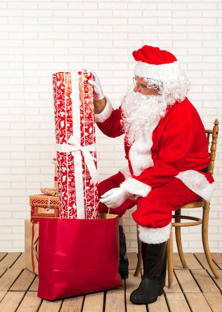 Santa Claus preparing gifts for Christmas 