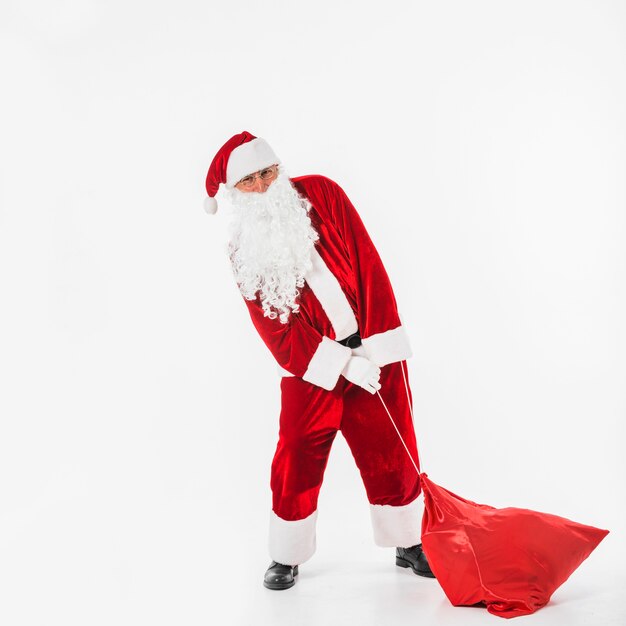 Santa Claus pulling sack of gifts 