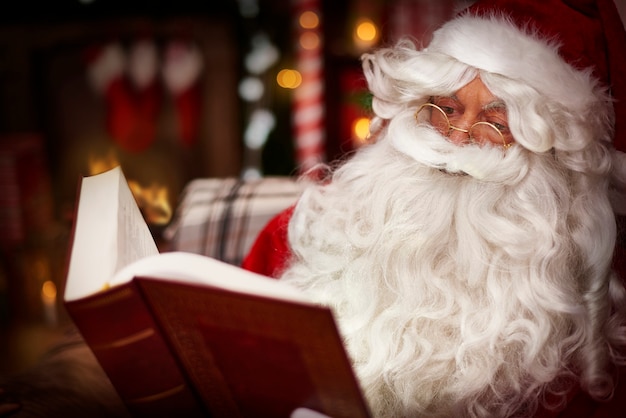 Santa claus reading Holy Bible in the home interior