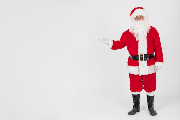 Free photo santa claus showing empty hand