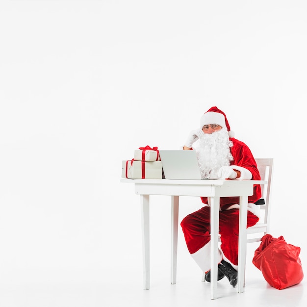 Santa Claus sitting on chair with sack