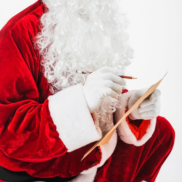 Free photo santa claus sitting with children list