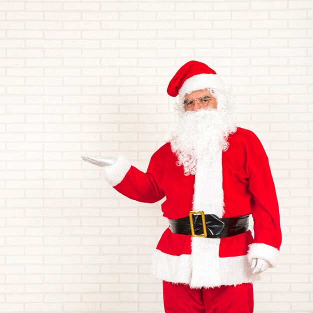 Santa Claus standing with outstretched hand