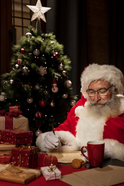 Santa claus surrounded by christmas gifts