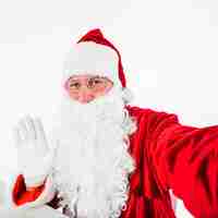 Free photo santa claus taking selfie with smartphone