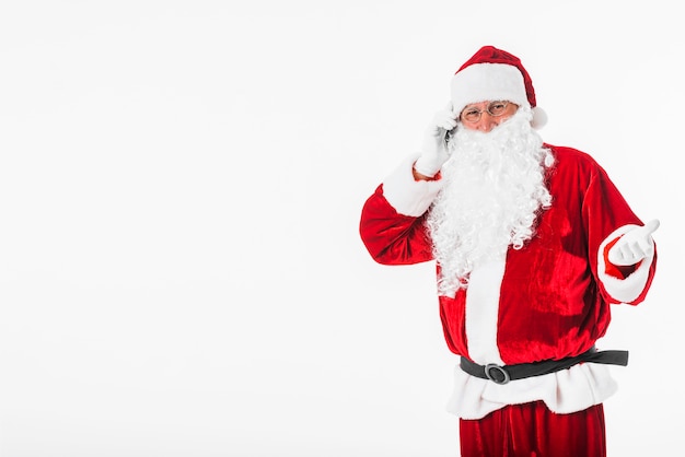 Free photo santa claus talking by phone