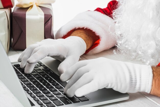 Santa Claus typing on laptop 