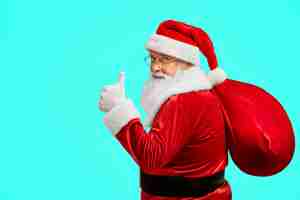 Free photo santa claus with bag showing thumb up.