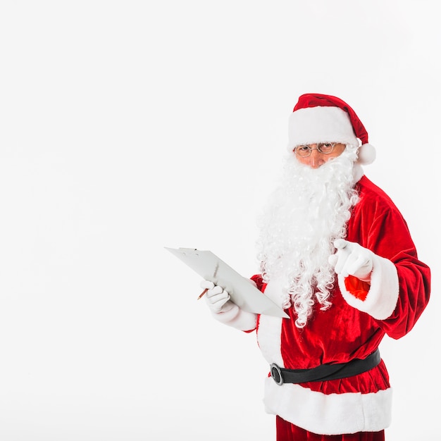 Санта-Клаус с клипбордом, указывающим палец на камеру