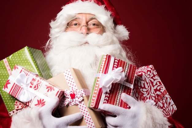 Free photo santa claus with a lot of gift boxes