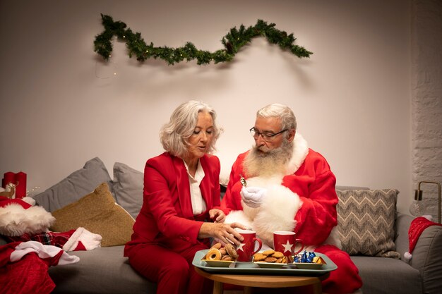 Santa claus and woman having cookies