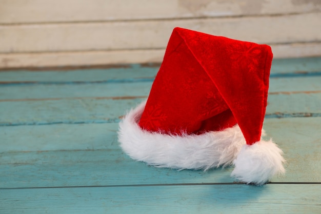 Santa hat on blue wooden boards