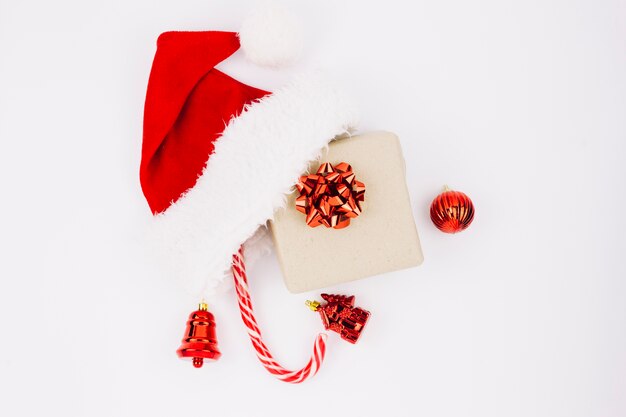 Santa hat with gift box on table 