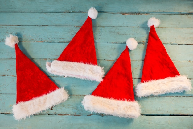 Santa hats on blue wooden boards