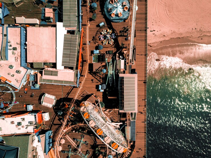 Free Photo santa monica amusement park with a roller coaster and ferris wheel in los angeles, california