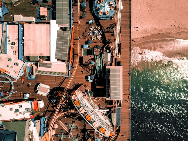 Santa Monica amusement park with a roller coaster and ferris wheel in Los Angeles, California