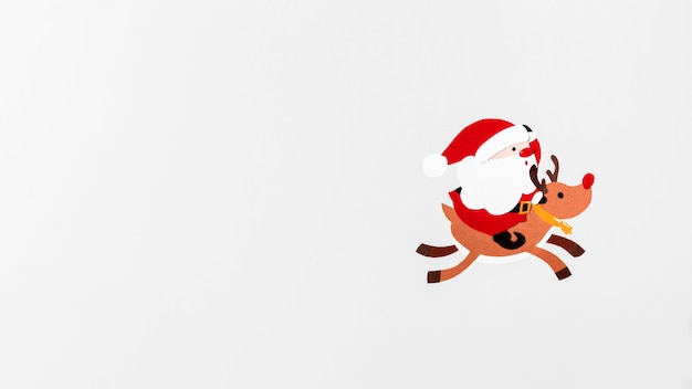 Free photo santa riding reindeer rudolph copy space