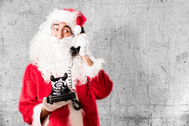 Free photo santa with and old phone