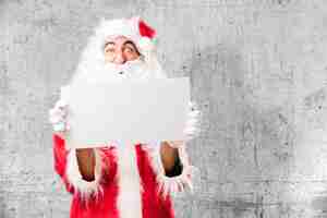 Free photo santa with a white poster