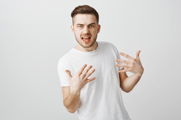 Sassy and cool guy show-off pointing at himself proud