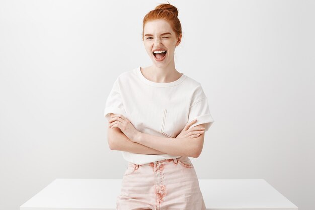 Sassy redhead girl smiling and wink joyfully