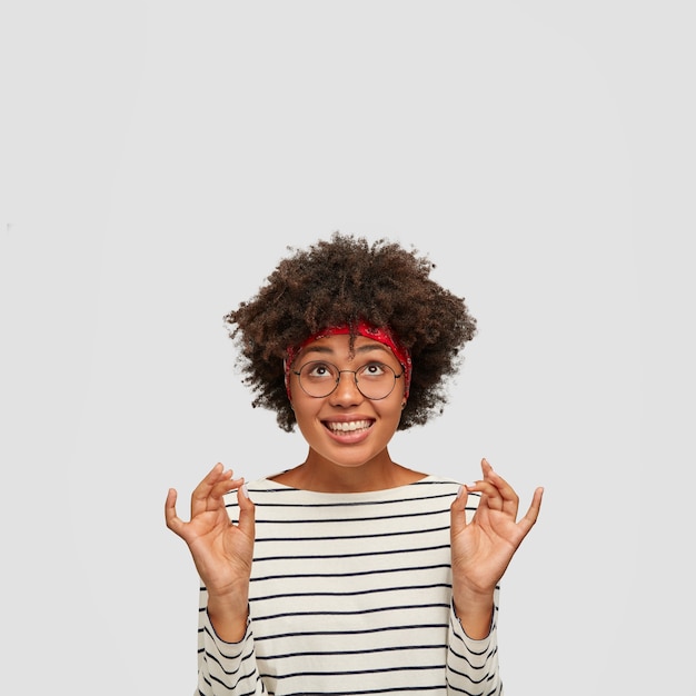 Satisfied black woman with cheerful expression