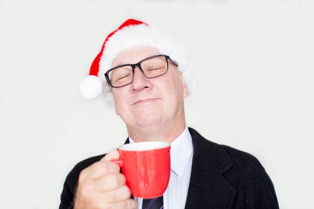 Satisfied businessman enjoying aroma of coffee