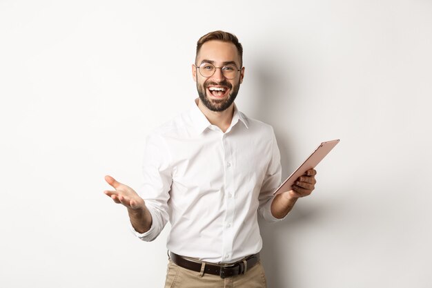 Satisfied businessman praising good work, reading report on digital tablet, standing happy  