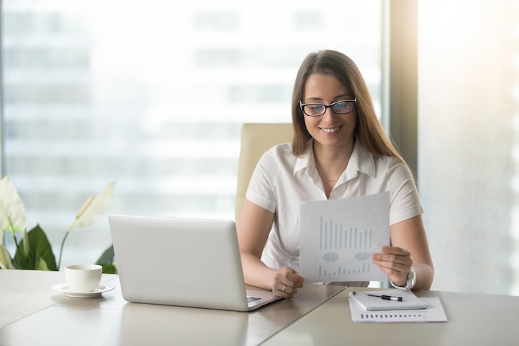Free Photo satisfied businesswoman revising financial results