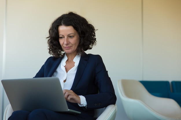 Satisfied businesswoman working on computer