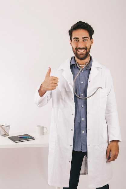 Satisfied doctor posing with thumb up