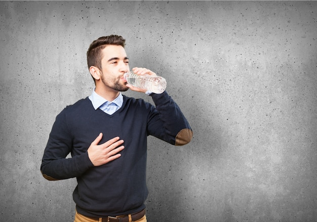 Satisfied guy drinking water