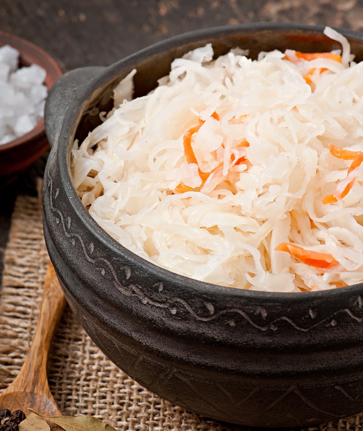 Free Photo sauerkraut with carrot in wooden bowl