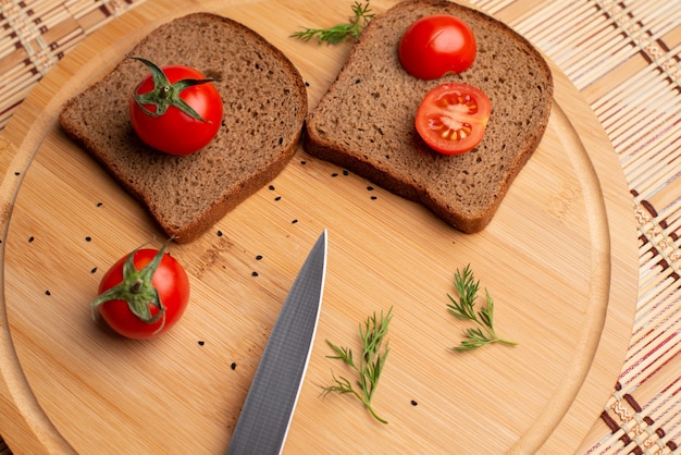黒パン​と​木製​の​背景​に​トマト​の​ソーセージ